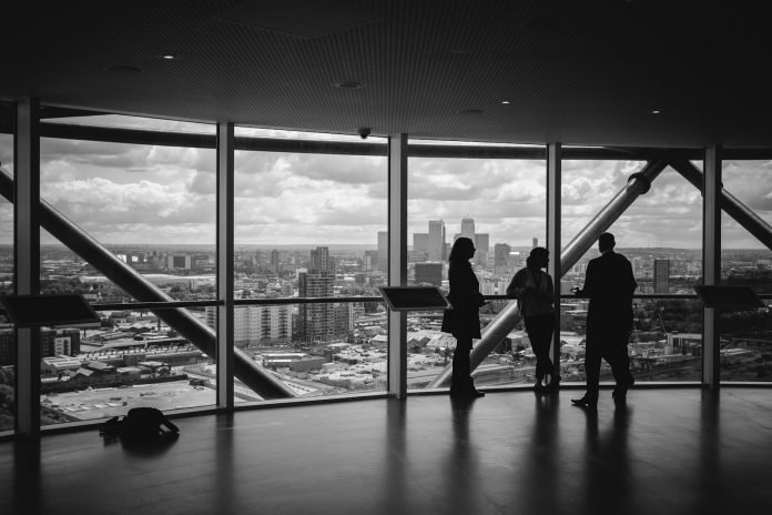 Photo by Charles Forerunner people standing inside city building