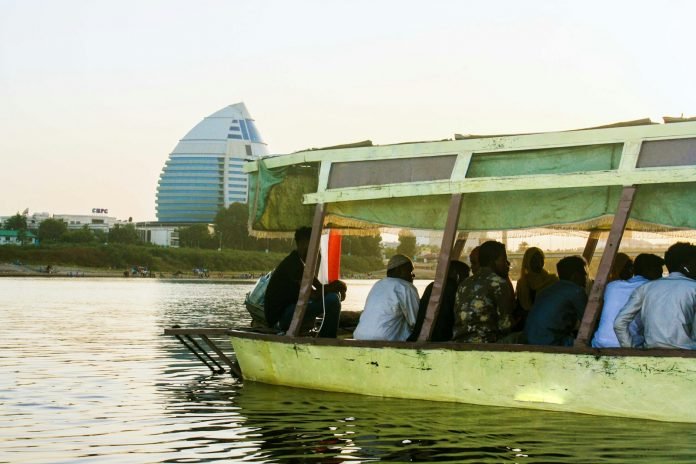 Photo by Musnany a group of people riding on the back of a boat