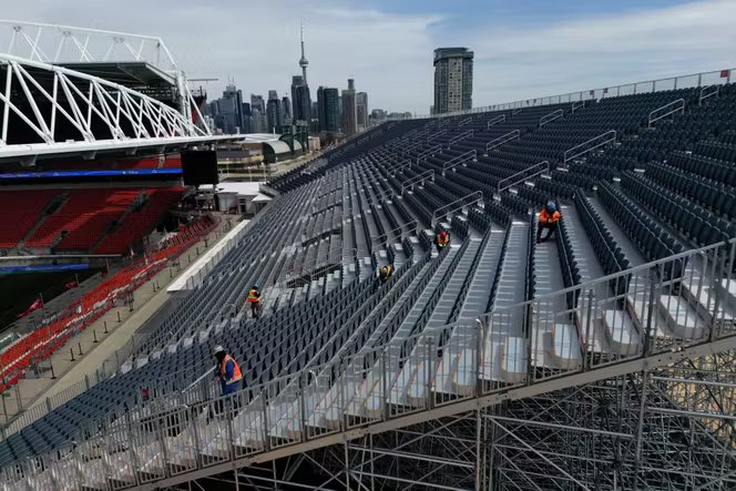 Des ouvriers installent des tribunes temporaires près des tribunes habituelles du stade BMO Field, à Toronto (Canada), le 24 mars 2026.