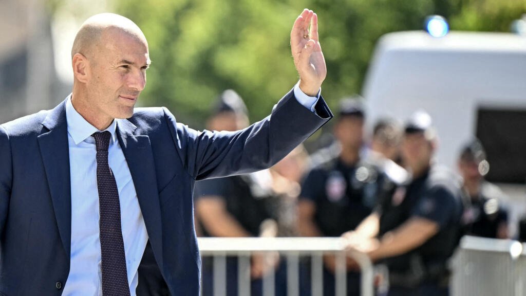 Le footballeur international français Zinédine Zidane salue les supporters alors qu'il quitte la conférence de presse organisée pour le présenter comme nouveau sélectionneur de l'équipe de France de football, au siège de la Fédération française de football (FFF) à Paris, le 28 juillet 2026.
